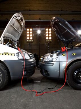 Roadside assistance van performing a vehicle jump start