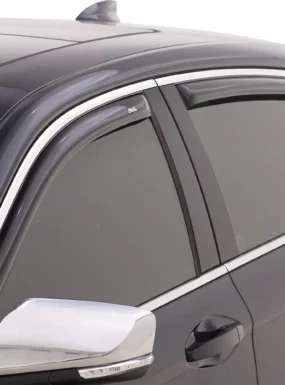 Technician installing a side window deflector on a sedan
