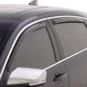 Technician installing a side window deflector on a sedan